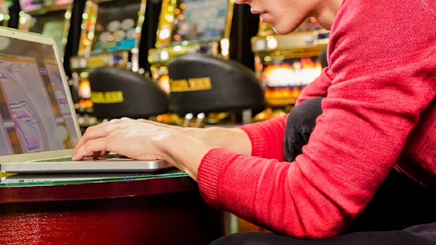 Man using his computer at a casino