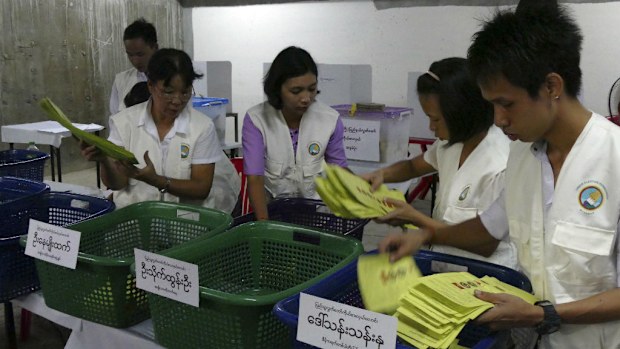Myanmar election commission officers count votes at a polling station in Yangon. (AAP)