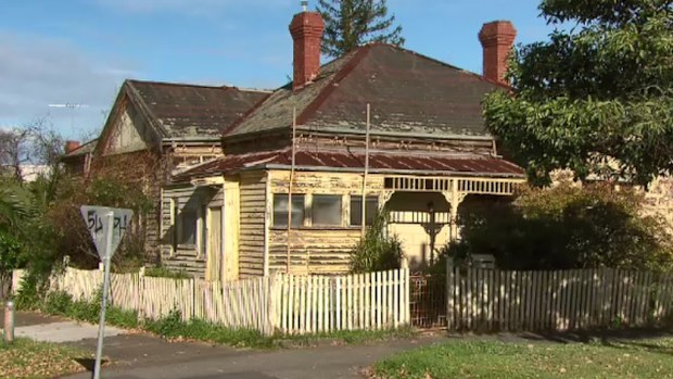Firefighters cut through the kitchen floor to free the woman. (9NEWS)