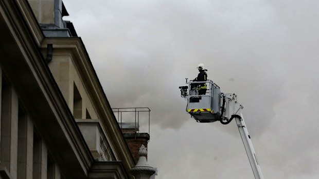 A firefighter inspects the fire at the Ritz Carlton Hotel in Paris. (AAP)