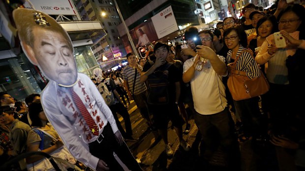 Pro-democracy protesters with a cardboard cutout depicting Hong Kong Chief Executive Leung Chun-ying. (AAP)