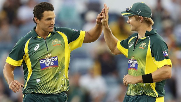 Australia's Shane Watson (right) congratulates teammate Nathan Couter-Nile after taking a wicket. (AAP)