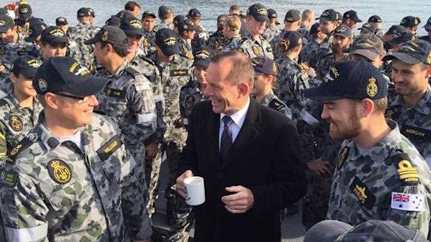 Prime Minister Tony Abbott at a BBQ breakfast on the flight deck of HMAS Anzac, in the Dardanelles, Turkey. (AAP)