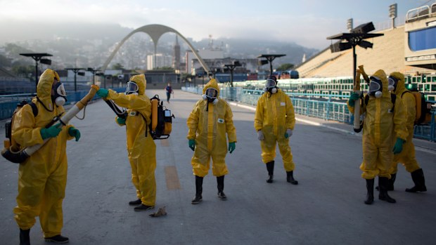 Health workers spray for mosquitoes at a stadium that will host Rio Olympics events. (AAP)