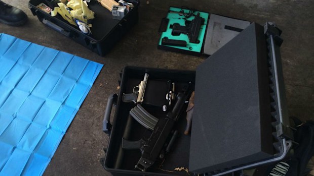 An UZI submachine gun (top in green case) and assault rifle and pistol seized by police in the raid. (NSW Police)