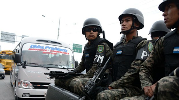 Honduras military police personnel patrol during a public transport strike. (Getty Images)