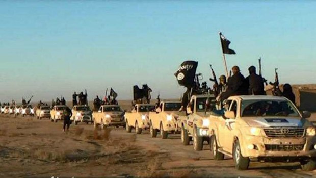 A convoy of vehicles and fighters from the Islamic State group travel through Iraq's Anbar Province. (AP)