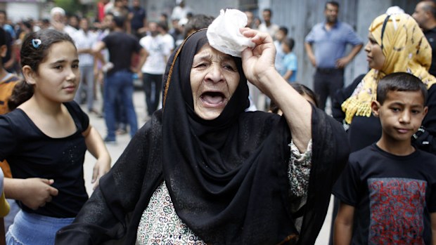 A Palestinian woman reacts during the funeral of nine people in Khan Yunis, in the southern Gaza Strip today.
