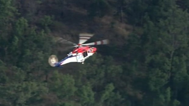 A rescue helicopter is attending the scene. (9NEWS)