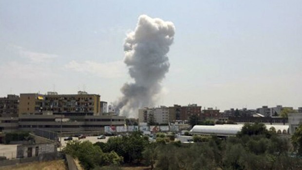 A plume of smoke rises from the Bruscella fireworks factory in Modugno near Bari, Italy. (AAP)
