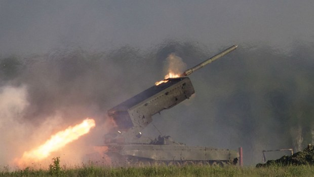 A Russian TOS-1A Solntsepyok (Sunheat) heavy flame throwing launcher fires during the Army-2015 show. (AAP)