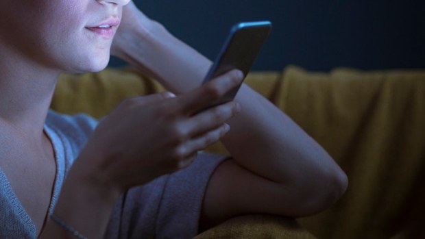 Woman using smart phone at night