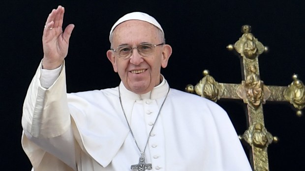 Pope Francis waves from the balcony of St Peter's basilica during the traditional "Urbi et Orbi" Christmas message to the city and the world, on December 25, 2016 at St Peter's square in Vatican. (AFP)
