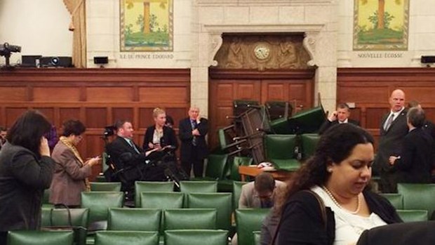 This photo taken by MP Nina Grewal shows MPs barricading themselves in after shots were fired inside parliament. (Picture: Twitter)