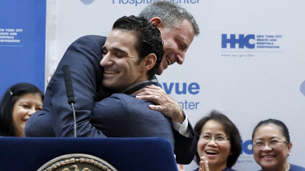 New York Mayor Bill de Blasio hugs Dr Craig Spencer after his release from hospital after surviving Ebola. (AAP)