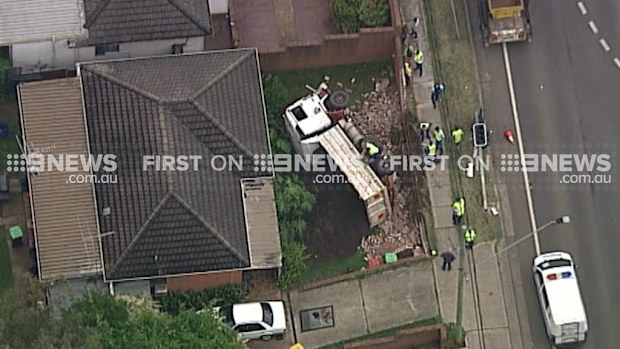 A truck has overturned in front of a Penrith house.