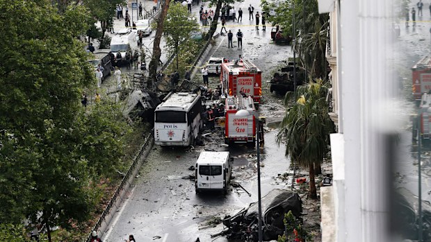 Police officers inspect the site of a bomb attack to a police bus. (AAP)