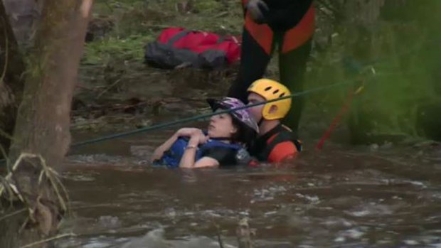 Three kayakers have been rescued after they became stranded on a log for two hours. (9NEWS)