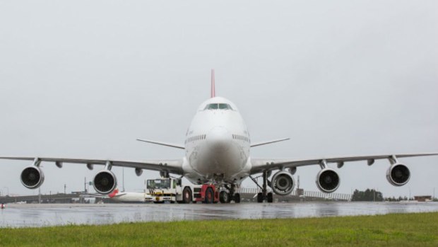 The Qantas 747 prepares to take off from Sydney with an extra engine on its left wing. (Qantas)