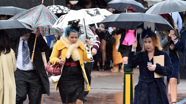 Racegoers are battling the cold to get a glimpse of Winx at this afternoon's Cox Plate. (AAP)
