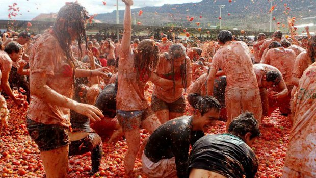 Hundreds of people participate in the Tomatina festival, a harvest event where participants throw tomatoes to each other. Picture: AP