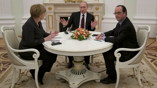 Russian President Vladimir Putin, centre, gestures during his talks with German Chancellor Angela Merkel, left, and French President Francois Hollande in Moscow, (AAP)