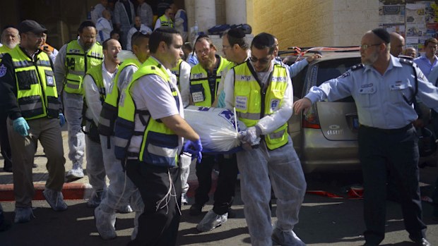 A body is carried out of the yeshiva Jewish seminary in Jerusalem. (AAP)