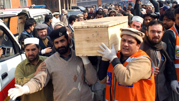 Pakistani volunteers move the coffin of a student from a hospital following the attack. (Getty Images)
