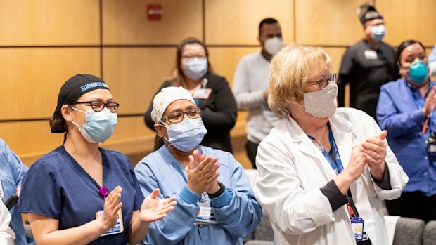Nurses celebrate with a standing ovation and cheer, "Elmhurst Strong!" 