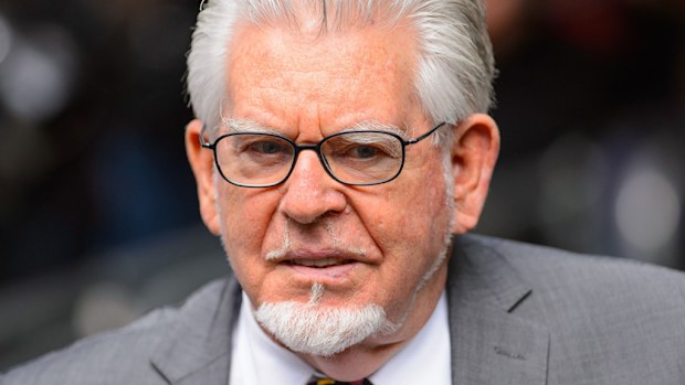 Rolf Harris will appear by video link from prison at his January trial.
