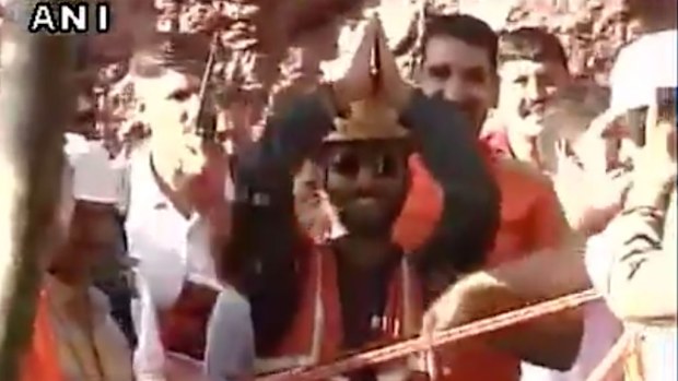 One of the workers celebrates being rescued from the tunnel.