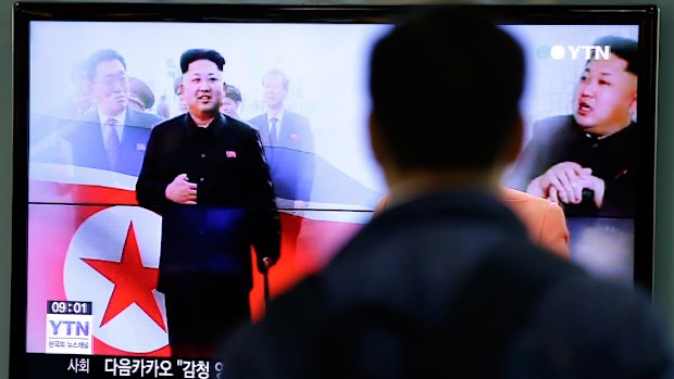 A man watches a TV news program showing North Korean leader Kim Jong-Un using a cane during his first public appearance. (AAP)