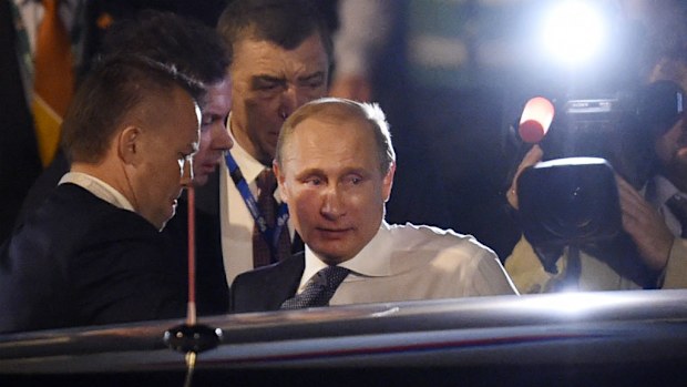 Russian President Vladimir Putin prepares to get into his heavily-armoured Mercedes-Benz limousine. (AAP)