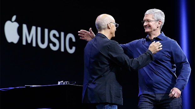 Apple CEO Tim Cook, right, hugs Beats by Dre co-founder and Apple employee Jimmy Iovine at the Apple Worldwide Developers Conference in San Francisco. (AAP)