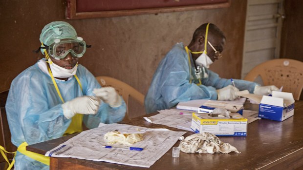 Health workers at a Sierra Leone hospital. The World Health Organisation says an Ebola vaccine could be readily available by 2015. (AAP)