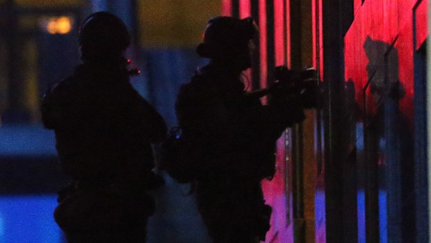 File photo: Two Special Operations Group officers stand ready to enter the Lindt cafe. (AAP)