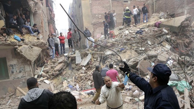 Workers continue the hunt for survivors after the building collapse in Cairo. (AAP)