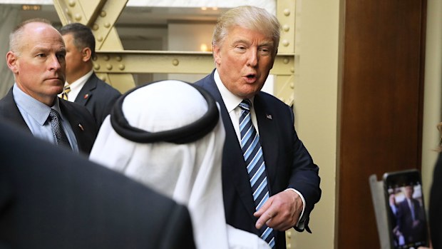 Republican presidential nominee Donald Trump is greeted by a guest following the grand opening ceremony at the new Trump International Hotel in Washington, DC on October 26, 2016. (AFP)
