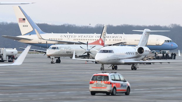 A US aircraft stands behind two other aircrafts as a police car drives by, at Geneva airport. (AAP)