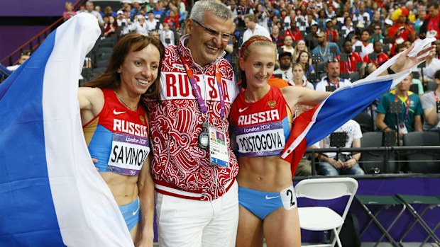 Mariya Savinova (L) and Ekaterina Poistogova (R) of Russia celebrate with Russian coach Vladimir Kazarin in London in 2012. (AAP)