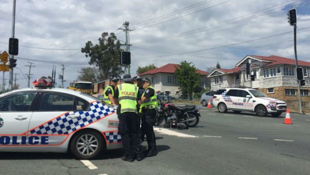 The motorbike rider died at the scene after colliding with a car at a Bardon intersection. (9NEWS)