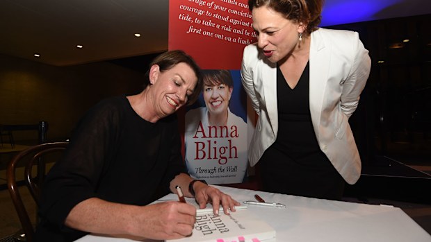 Anna Bligh signs a copy of her book Through the Wall. (AAP)