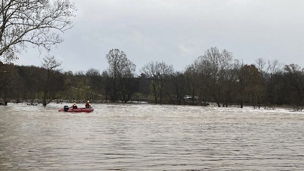 Patrol vehicles and rescue boats are from rescue efforts on a swollen river in Manes.