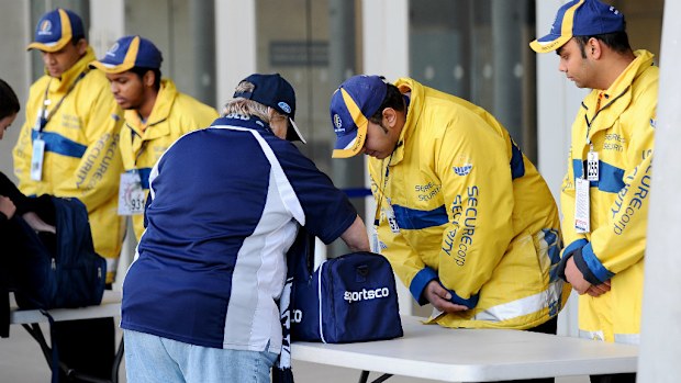 Security checks a patron's bag during the 2014 AFL finals series. (AAP)
