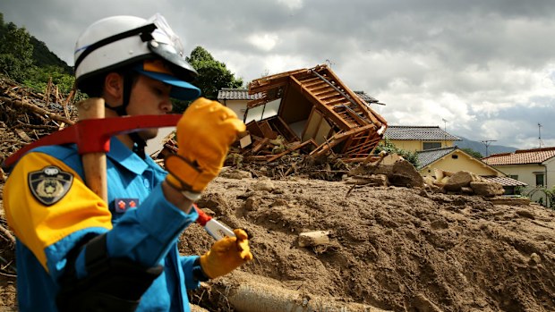 Rescue teams continue the search for missing people among the debris of houses destroyed by a landslide. (Getty Images)