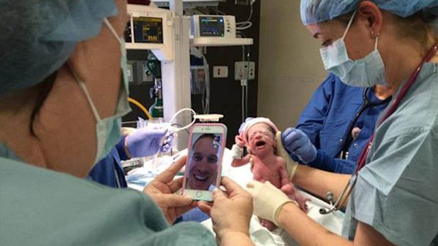 Army dad uses FaceTime to see his quadruplets born. (Adventist Hinsdale Hospital/ Facebook)