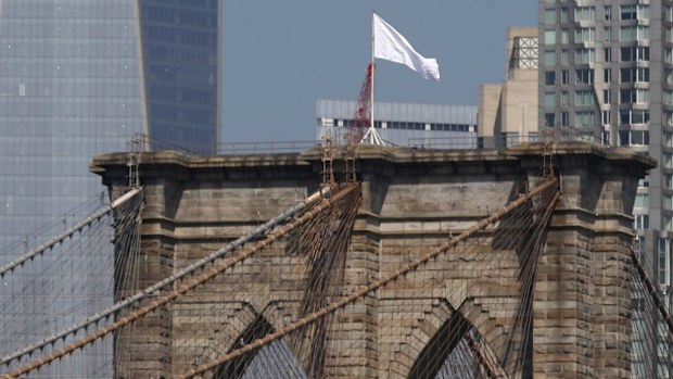 The white flags fly atop the Brooklyn Bridge. (AAP)