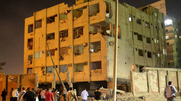 People gather near the scene where a bomb exploded in Cairo.