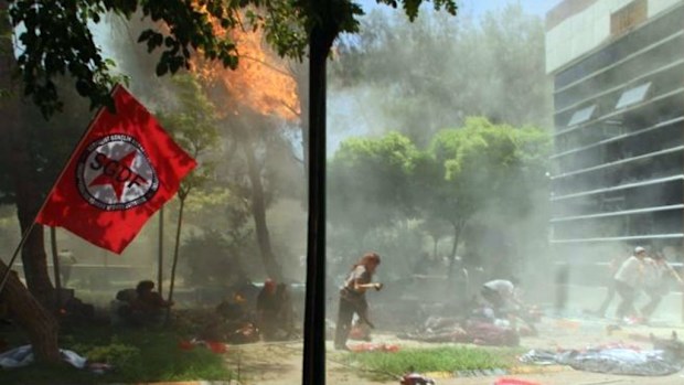 People run away during an explosion at a cultural center in Suruc in Turkey.