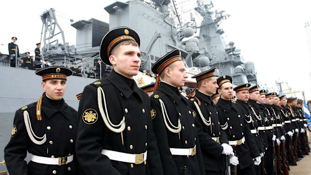 Russian sailors in front of the guided-missile cruiser Varyag, which is part of the Russian fleet north of Australia. (AAP)
